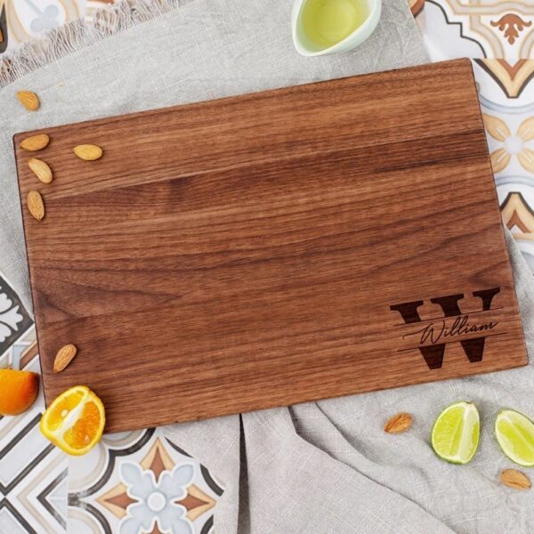 Monogrammed wooden cutting board made from walnut.