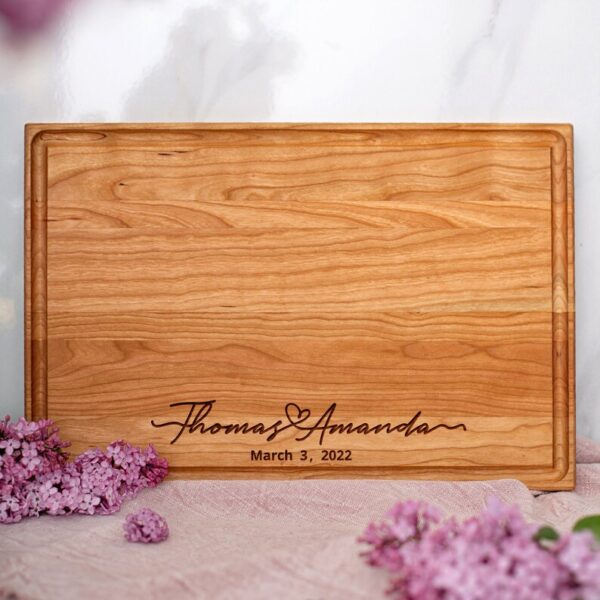 A personalized cutting board with lilac flowers, perfect as a wedding gift.