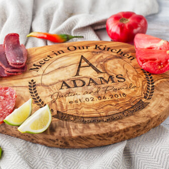 A Personalized Olive Wood Charcuterie Board with meat and vegetables on it.