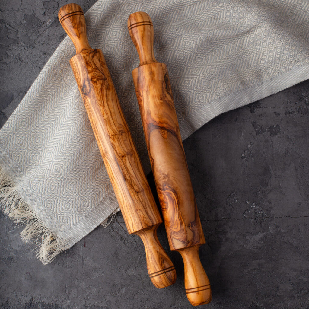 Two wooden rolling pins on top of a cloth.