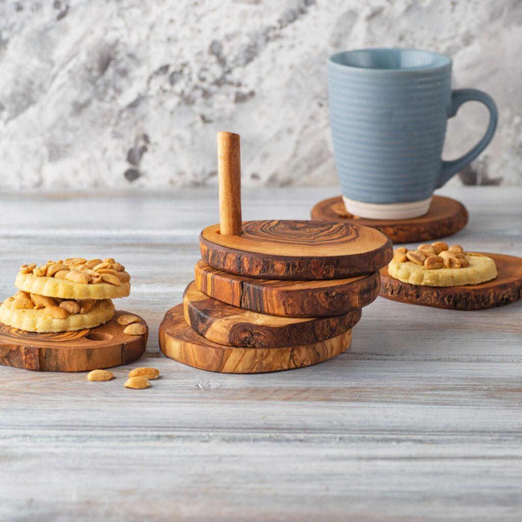 A set of wooden coasters with nuts and a cup of coffee.