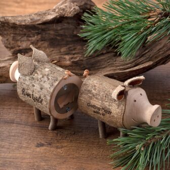 Two wooden Piggy Bottle Opener for Beer, on a wooden table.
