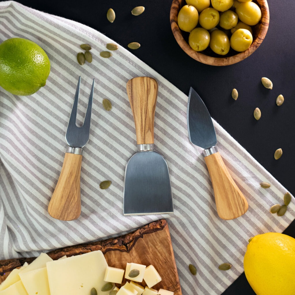A cheese board with cheese, olives, and lemons.