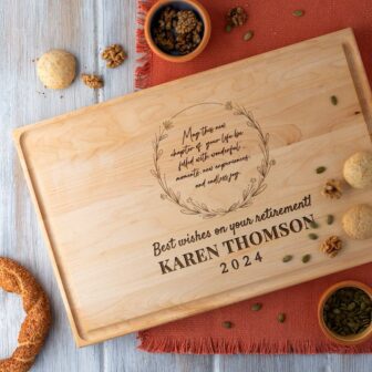 A wooden cutting board with a quote on it.