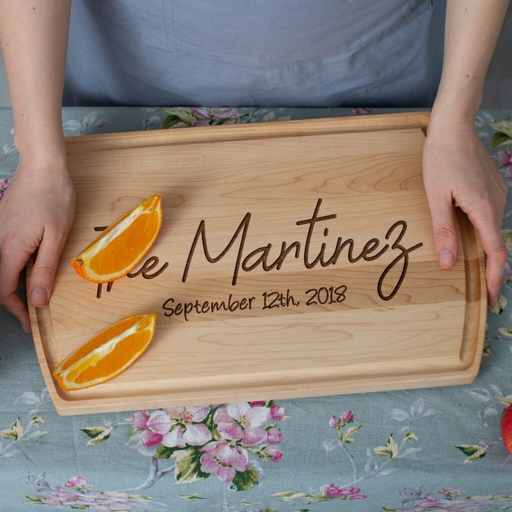 A woman is holding a Personalized Cutting Board with the words' the Martinez family'.