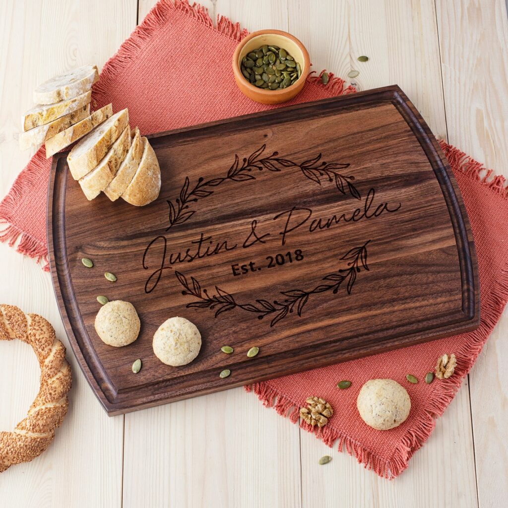Personalized walnut cutting board with flower design.