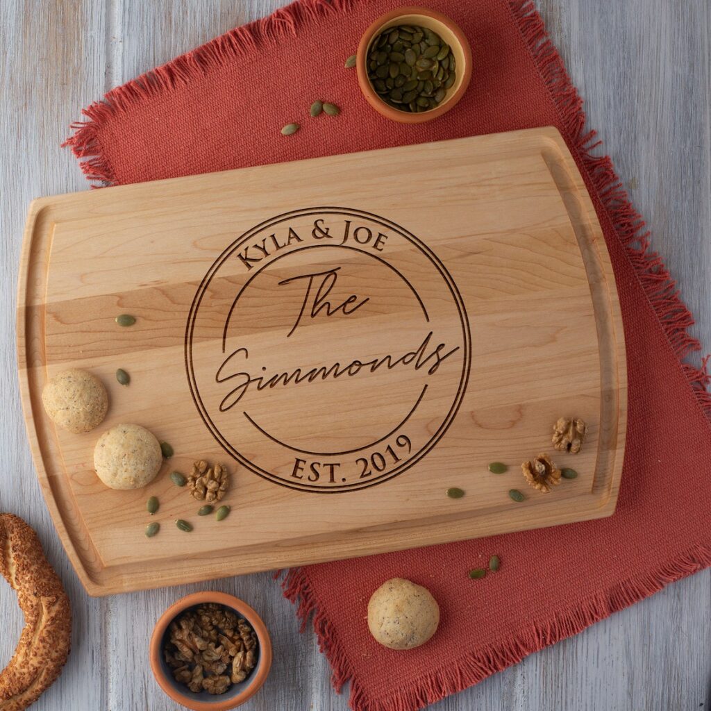 An Engraved Cutting Board Personalized with the name of the bride and groom.