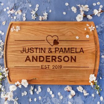 Wood Anniversary Cheese Board with the words Justin and Pamela Anderson on it.