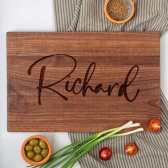 A wooden cutting board with the name Richard on it as unique housewarming gifts .