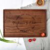 personalized wooden wedding gift cutting board on top of a kitchen counter.