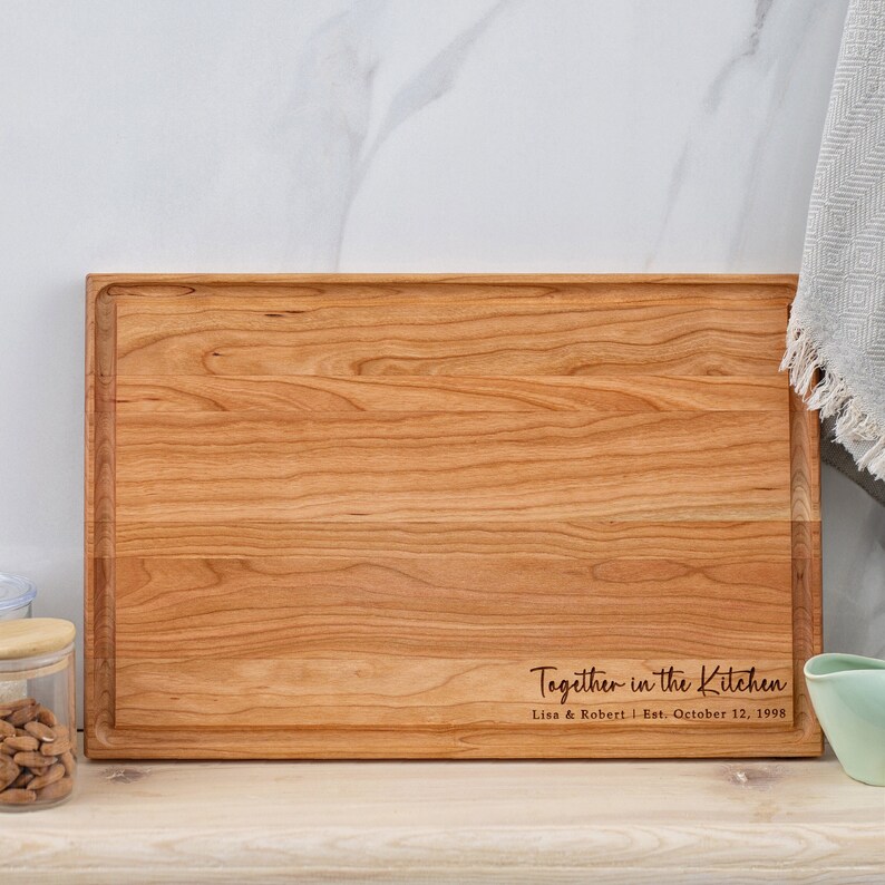 Custom Cherry Wood Cutting Board with engraving in the lower right corner.