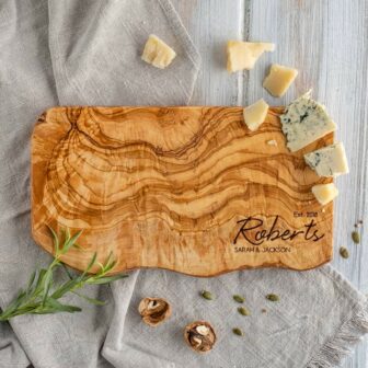 A wooden serving board personalized with the name "Robert's.