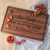 A walnut cutting board with the words'the master chef'on it.