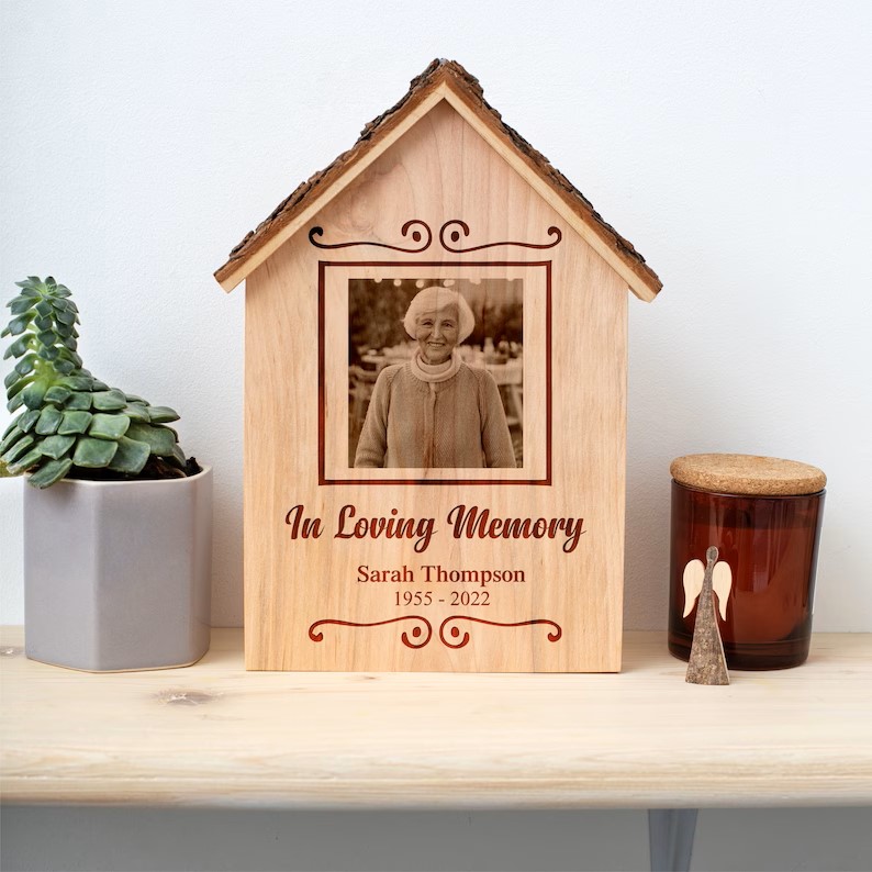 A wooden photo frame with a photo of a woman in a living memory.