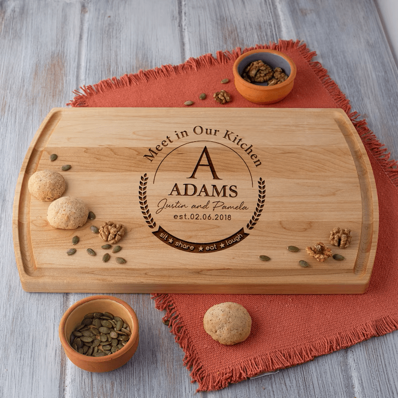 A Custom Monogram Wooden Board with acorns and nuts on it.