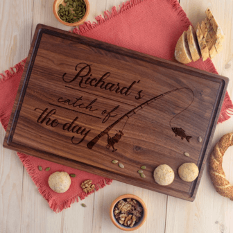 Customized Walnut Wood Cutting Board with the words Richard's catch of the day.