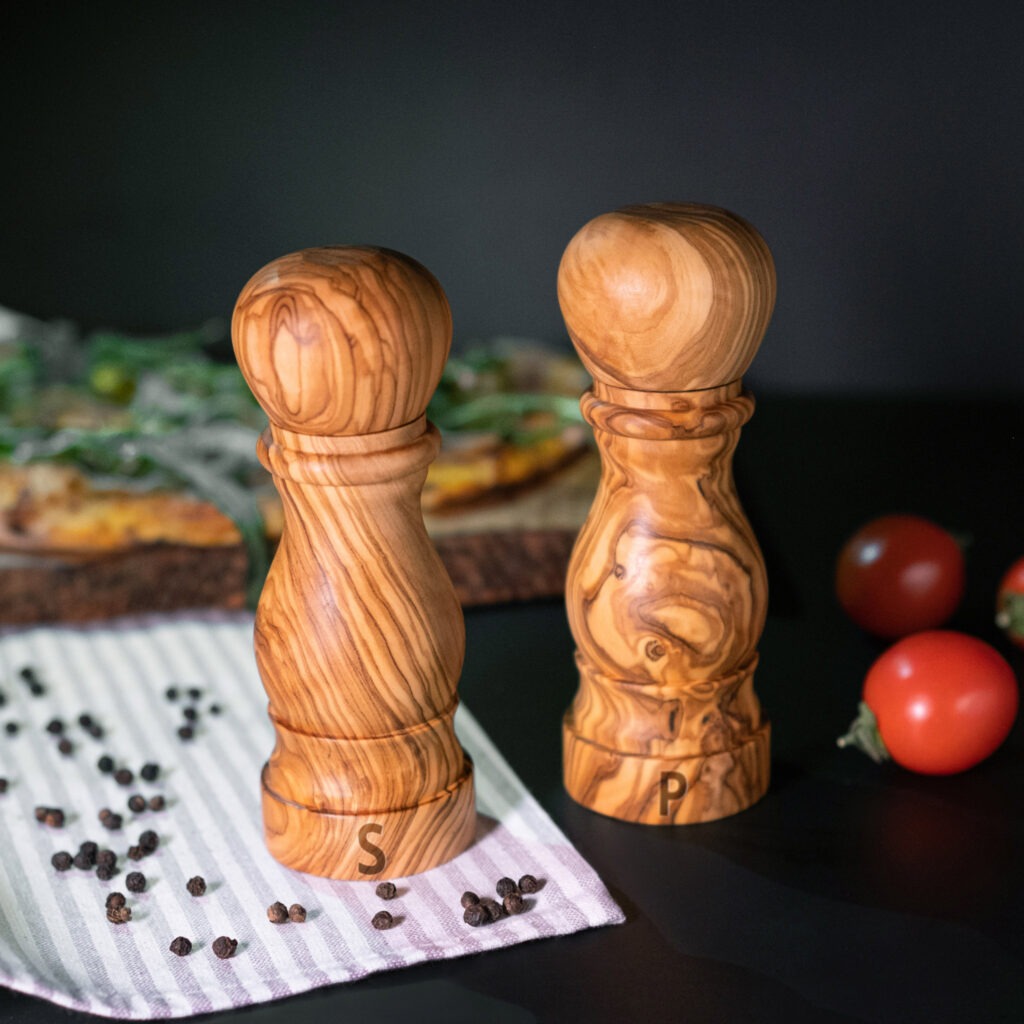 Two wooden salt and pepper mills on a table.