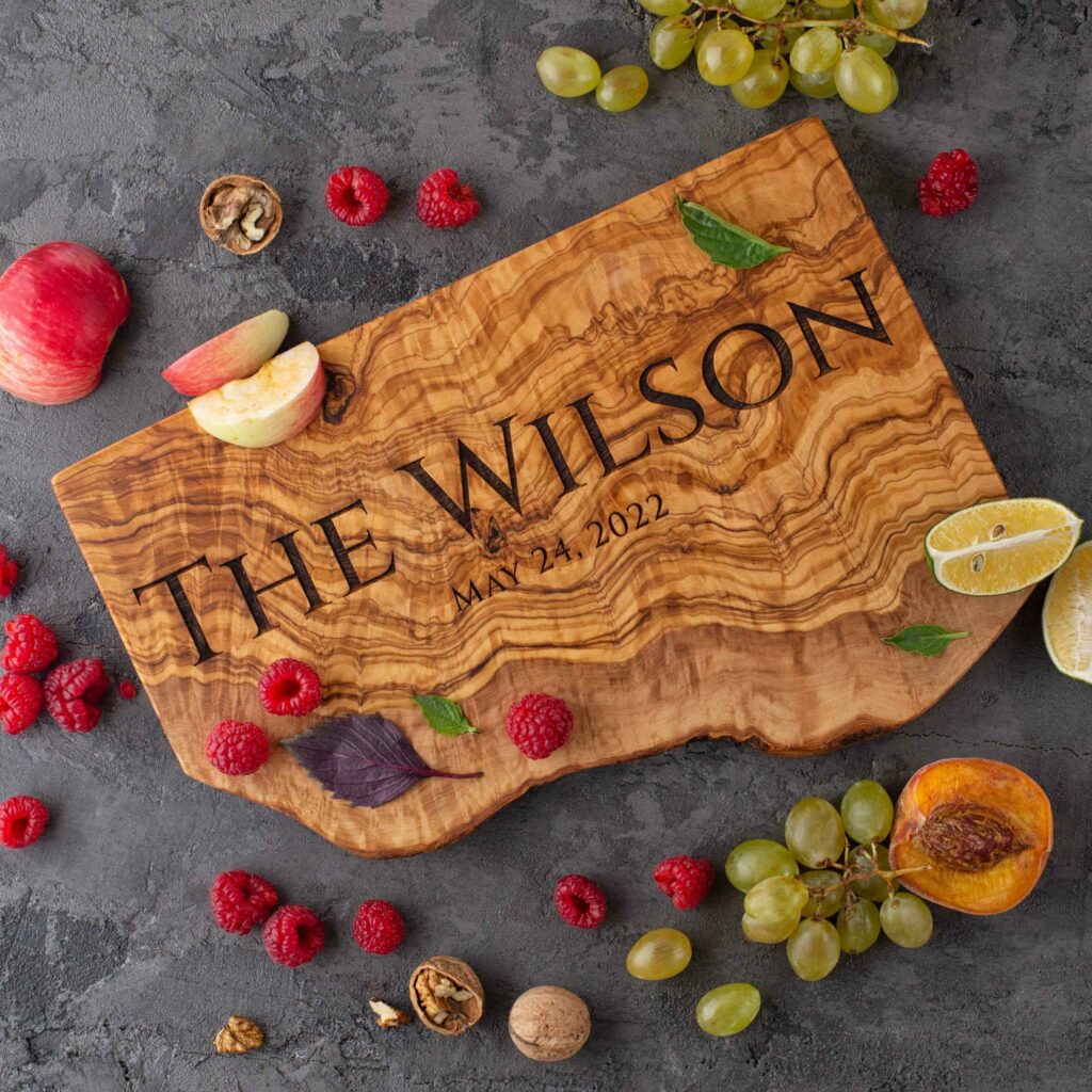 An Olive Wood cutting board with the name the Wilson on it.