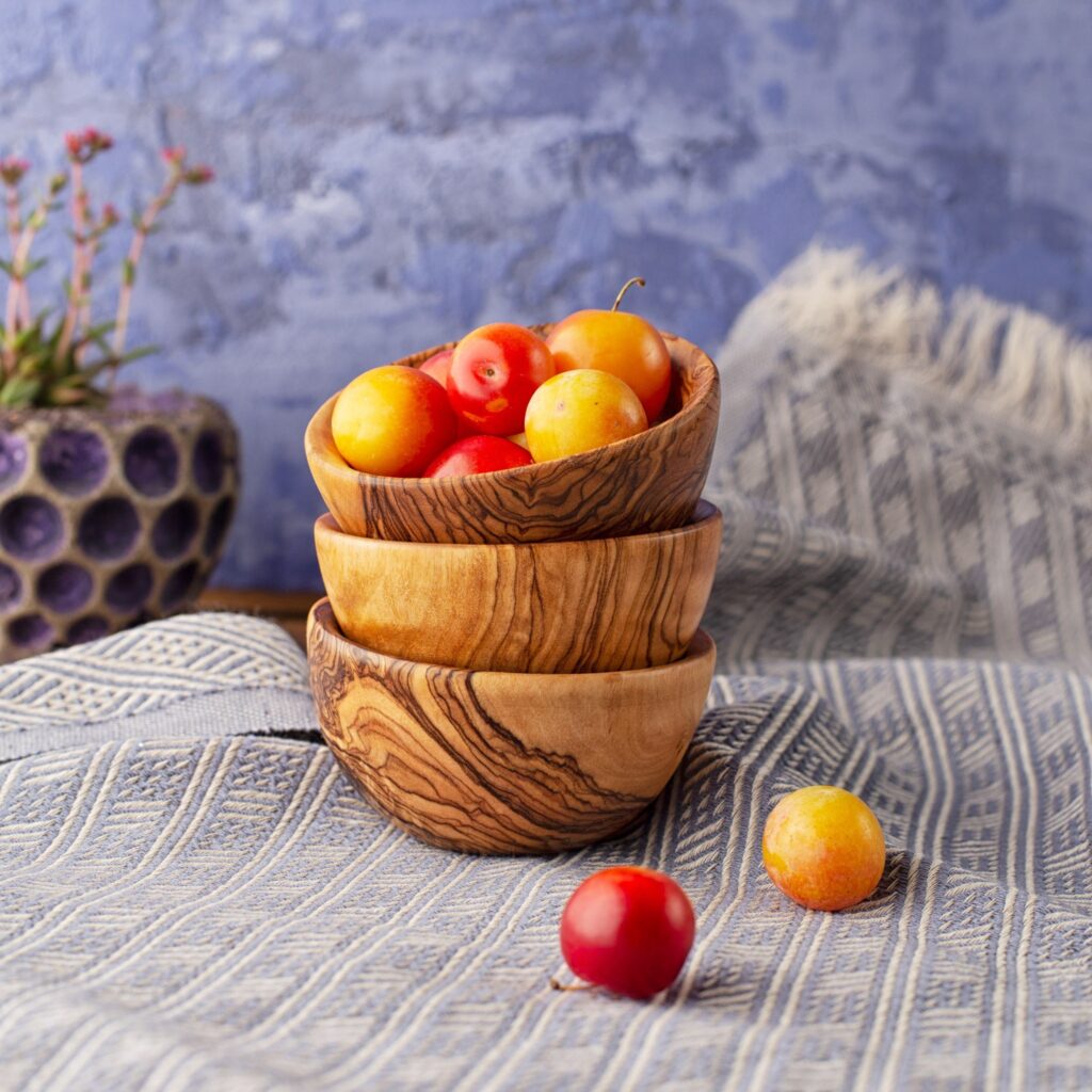 Three wooden bowls stacked on top of each other.