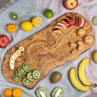 A wooden cutting board with fruit on it.