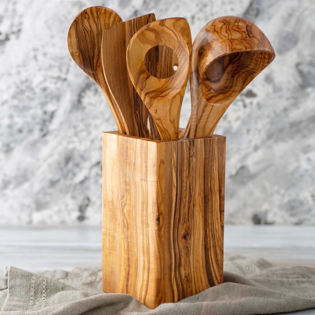A set of olive wood spoons in a wooden box.
