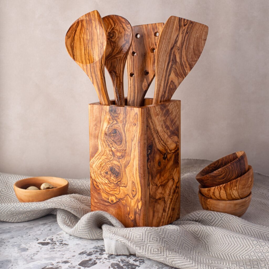 A set of wooden utensils in a wooden box.