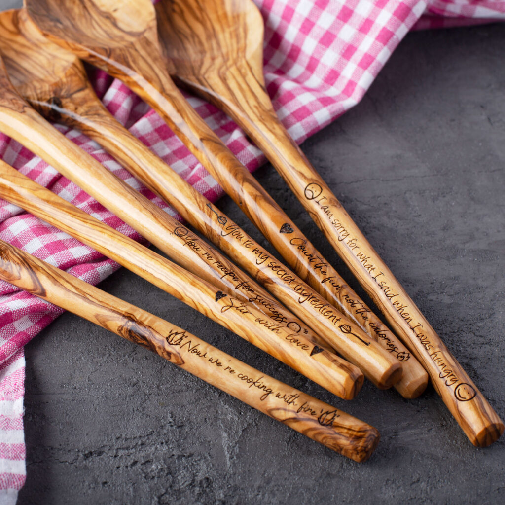 A set of wooden spoons with a red and white checkered cloth.