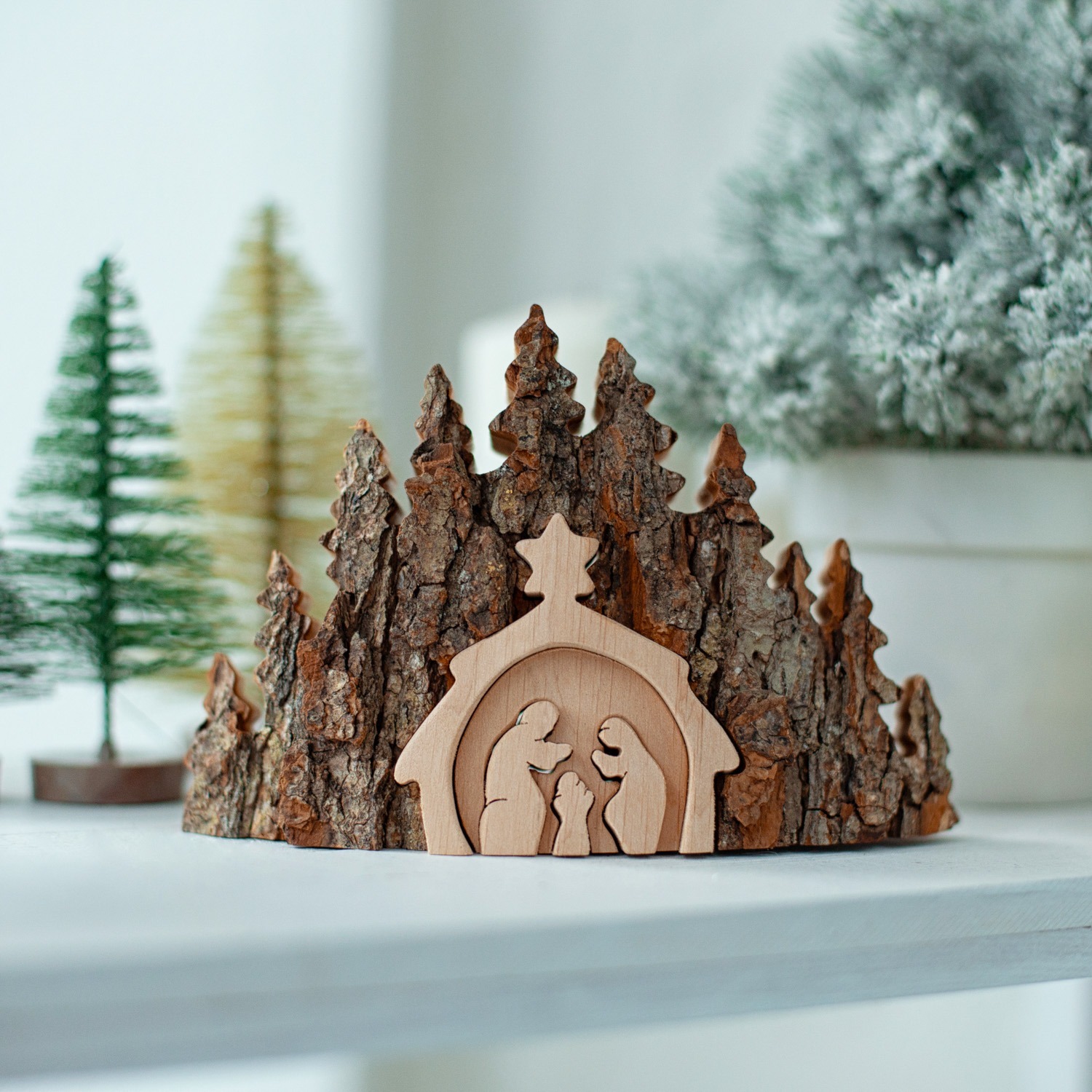 A wooden nativity scene on a shelf.