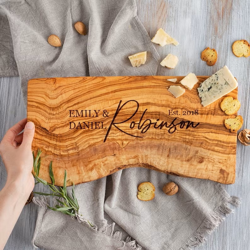 personalized live edge charcuterie board with engraved couple's first names, last name and date.