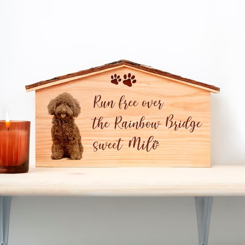 A wooden house with a poodle on it and a candle.