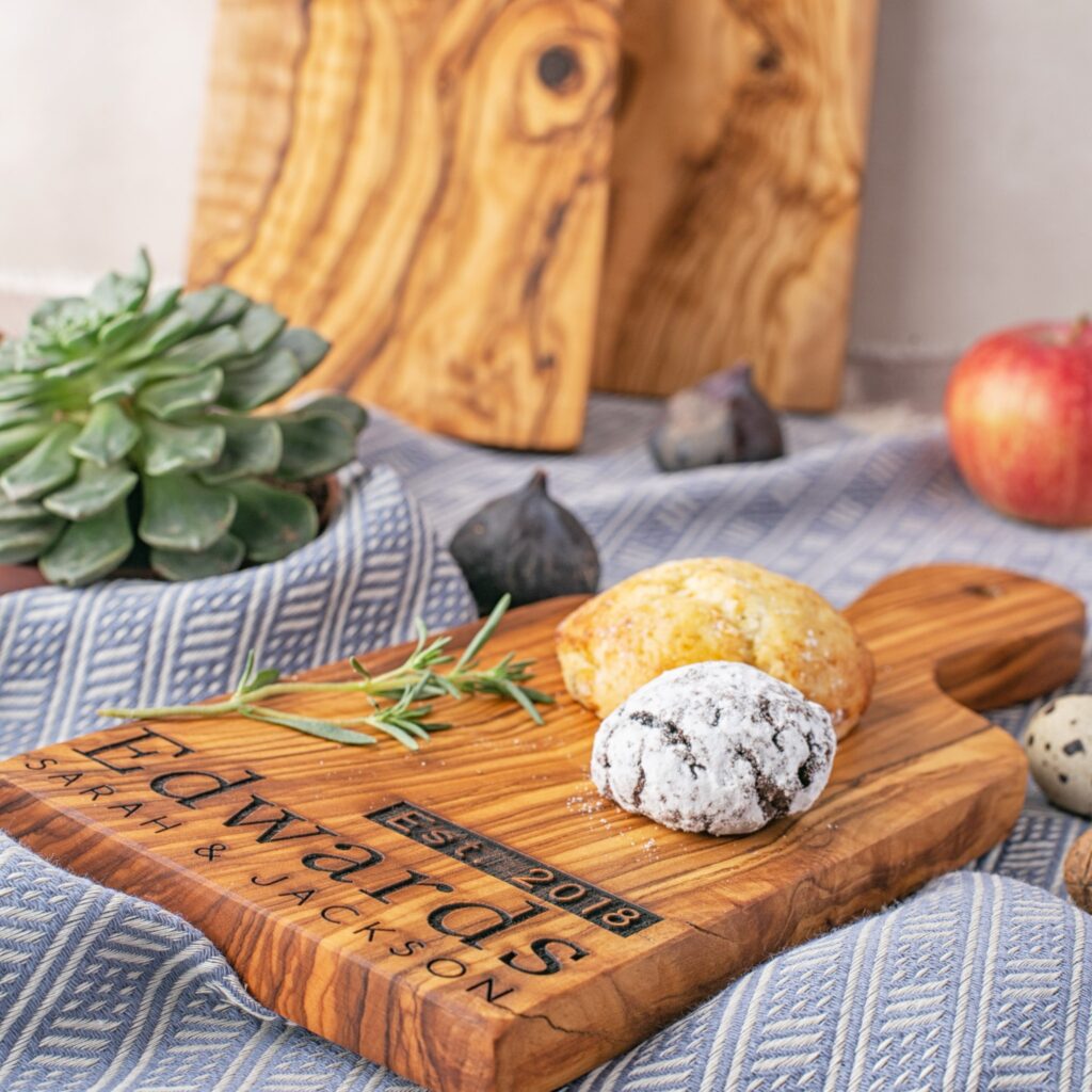 A Personalized Olive Wood Paddle Board with a pastry on it.