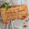 A handcrafted personalized charcuterie board featuring the names.
