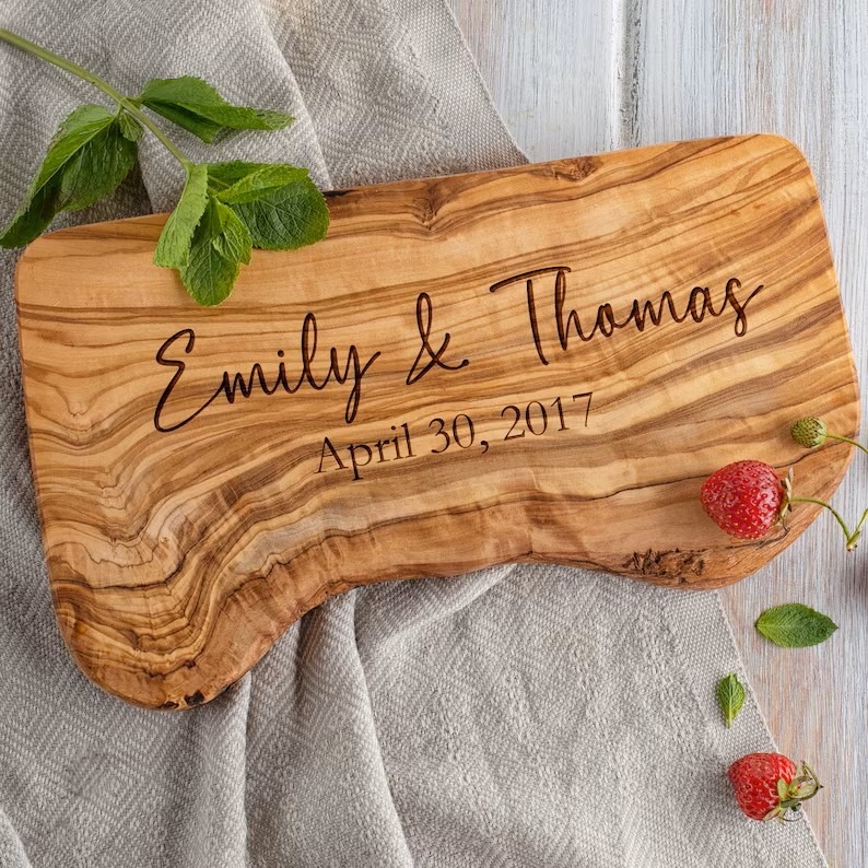 A handcrafted personalized charcuterie board featuring the names.