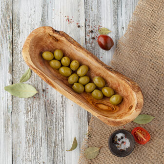 Olives in a wooden bowl.