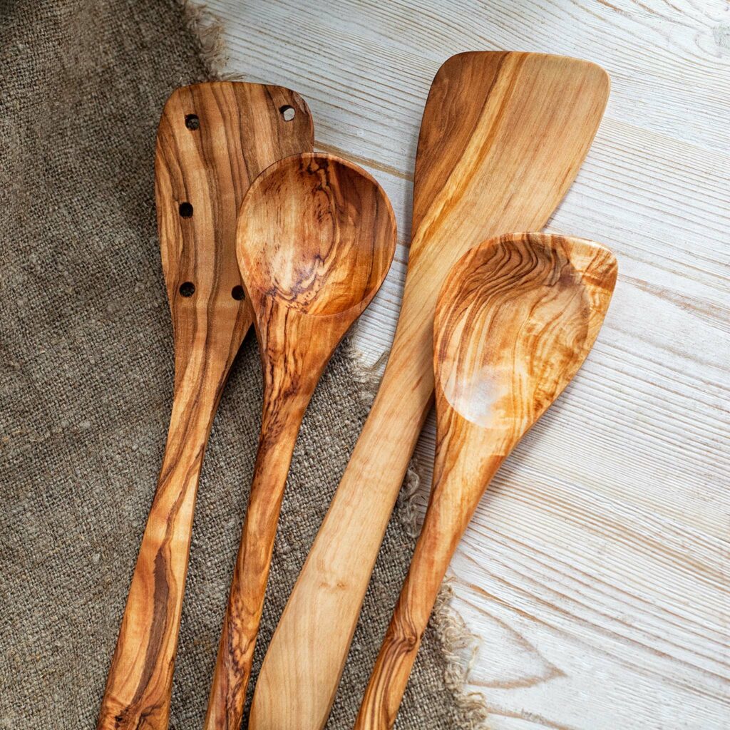 Three wooden spoons on a wooden table.