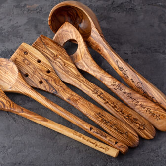A set of wooden utensils with writing on them.
