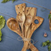 Wooden cooking utensils on a blue background.