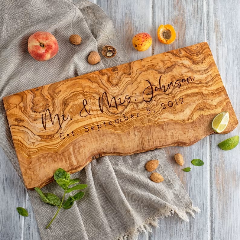 Live edge charcuterie board with engraving of couple's last name and date.