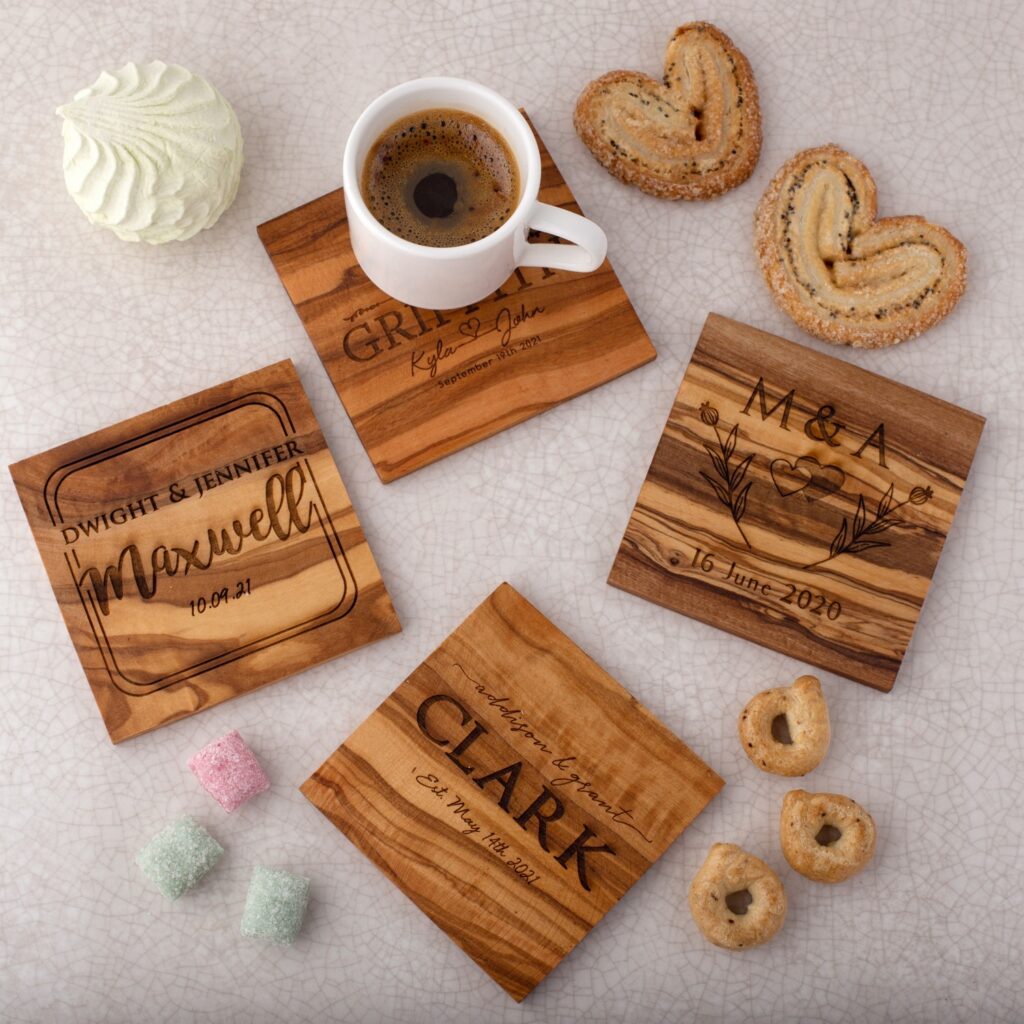Four wooden coasters with a cup of coffee and cookies.