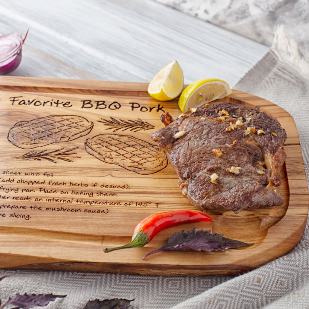 A Custom Recipe Cutting Board with a steak on it.