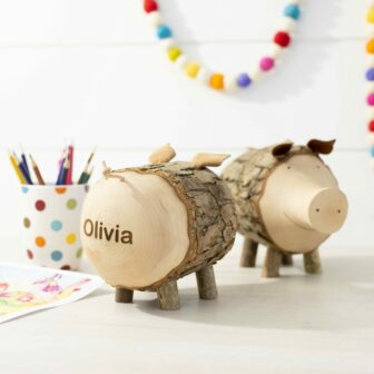 Two wooden pigs with the name olivia on them.