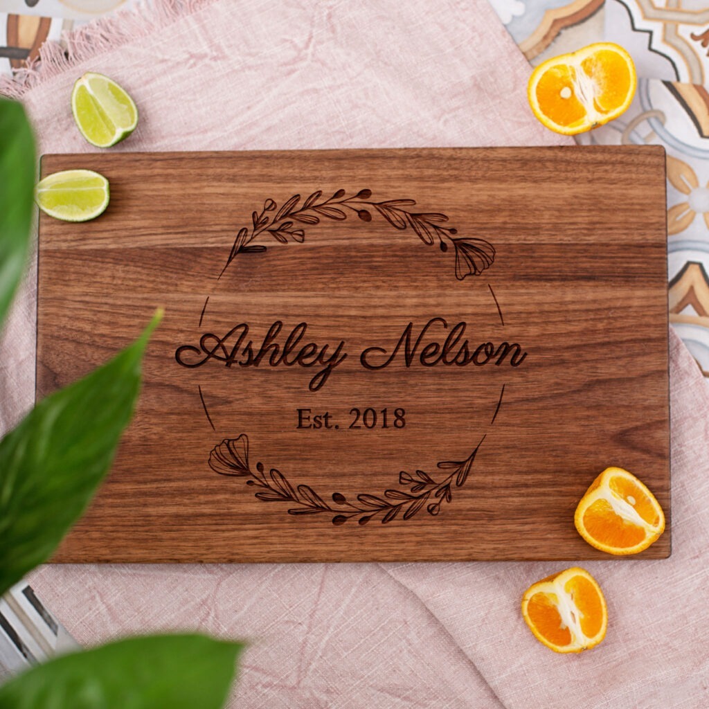 A wooden cutting board with the name ashley nelson.