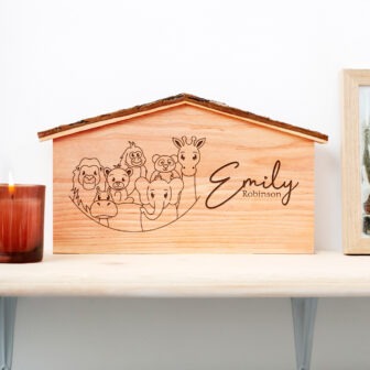 A wooden nativity scene with the name elly on it.
