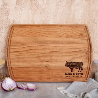 A wooden cutting board with an image of a cow and onions.