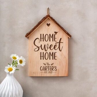 A wooden sign that reads home sweet home.