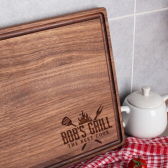A wooden cutting board with the words bob's grill on it.