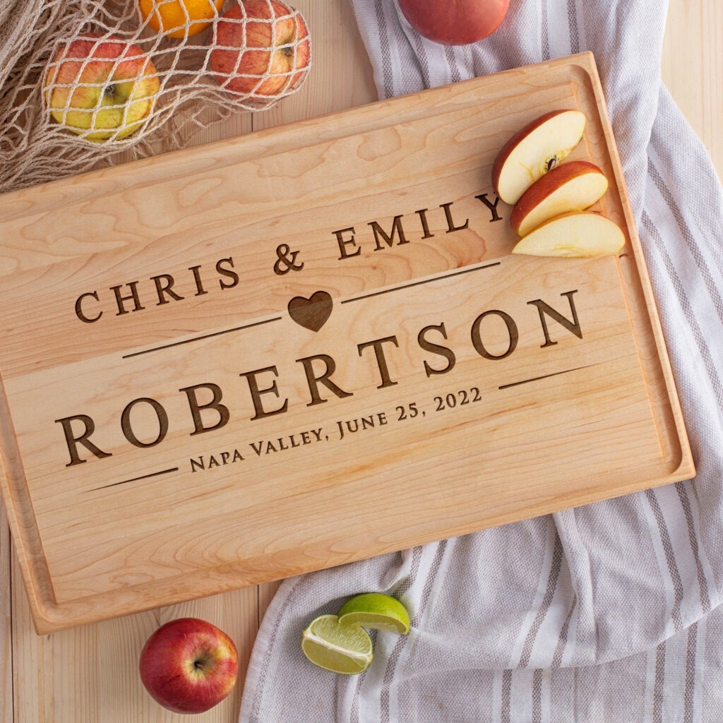 A wooden cutting board with the name chris and emily robertson.