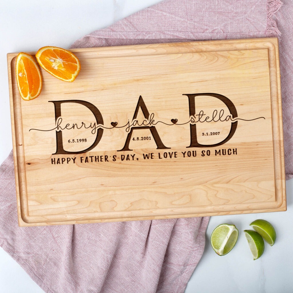 A wooden cutting board with the word dad on it.
