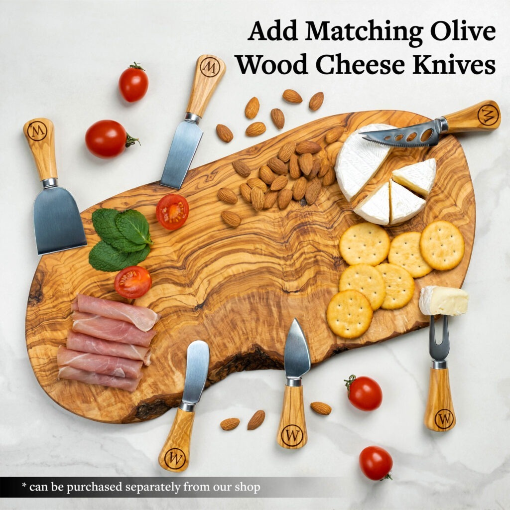Olive wood cheese board with a selection of crackers, meats, cheese, and almonds, accompanied by olive wood handled cheese knives.