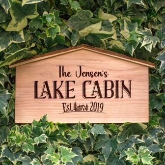 A wooden sign that says the jennifer's lake cabin.